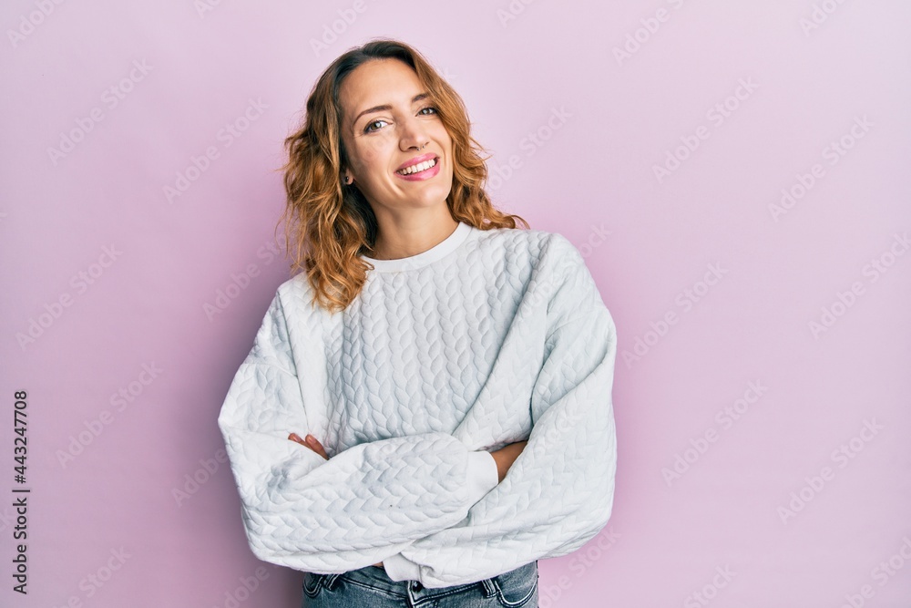 Fototapeta premium Young caucasian woman wearing casual clothes happy face smiling with crossed arms looking at the camera. positive person.