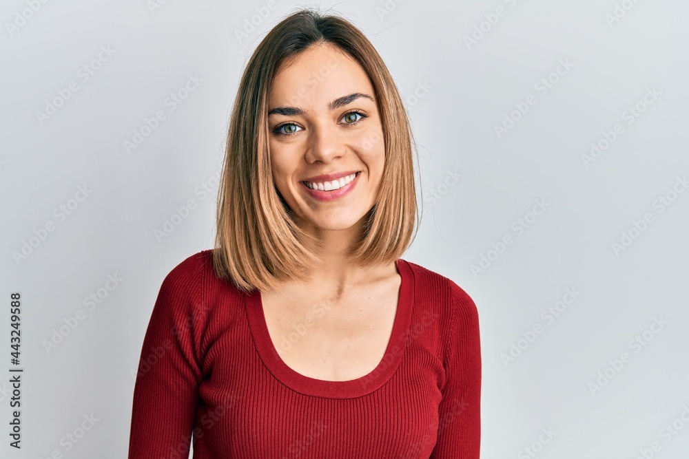 Young caucasian blonde woman wearing casual jumper with a happy and cool smile on face. lucky person. Young caucasian blonde woman wearing casual jumper with a happy and cool smile on face. lucky person.