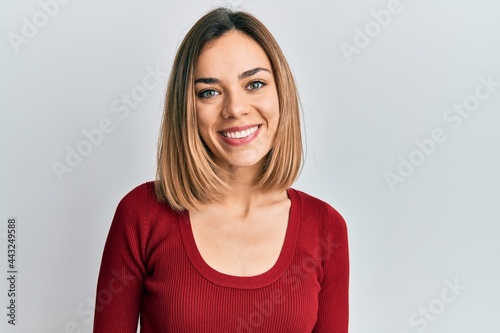 Young caucasian blonde woman wearing casual jumper with a happy and cool smile on face. lucky person.