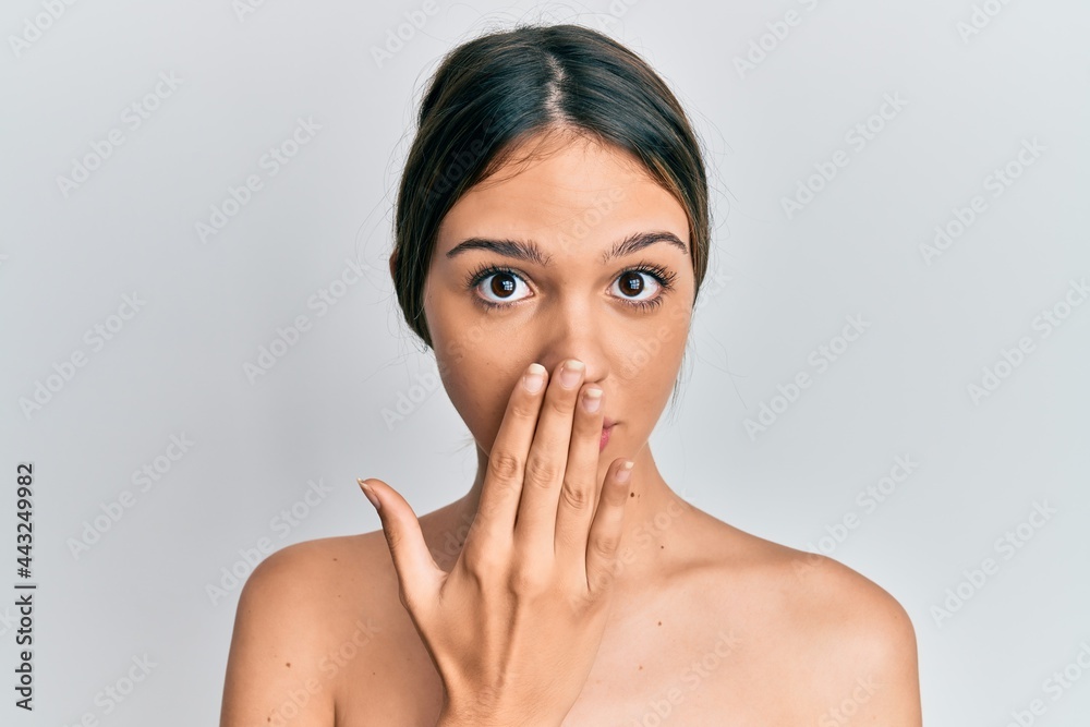 Young brunette woman standing topless showing skin covering mouth with hand, shocked and afraid for mistake. surprised expression Young brunette woman standing topless showing skin covering mouth with hand, shocked and afraid for mistake. surprised expression