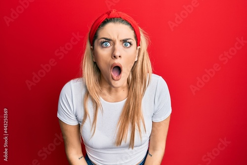 Young caucasian woman wearing casual white t shirt afraid and shocked with surprise and amazed expression, fear and excited face.