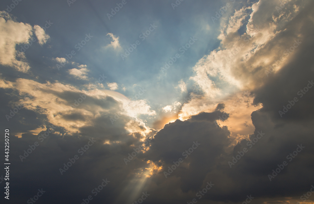 The sun shines through the clouds in the sky.  The shape of the clouds evokes imagination and creativity. They can be used as wallpapers that look amazing. Copy space, No focus, specifically.