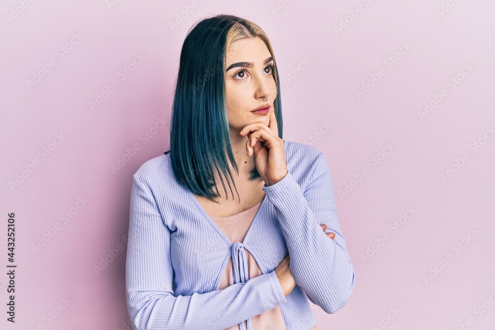 Young modern girl wearing casual jacket thinking concentrated about doubt with finger on chin and looking up wondering Young modern girl wearing casual jacket thinking concentrated about doubt with finger on chin and looking up wondering