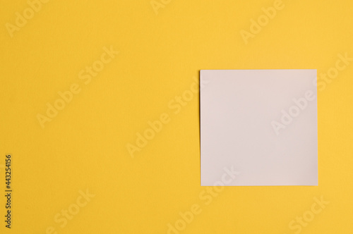 Memo note isolated on yellow background. Copy space for the text.