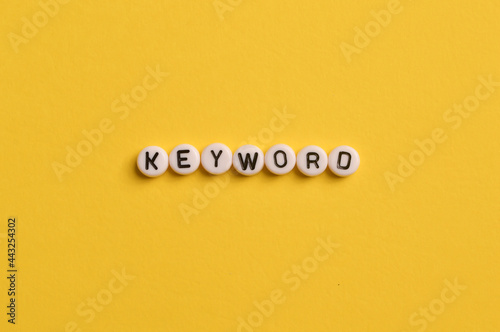 Alphabet letters with text KEYWORD isolated on yellow background