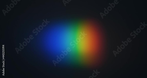 Shining a spot of light in the form of a rainbow. Spectral decomposition of light into rainbow colors. Black background