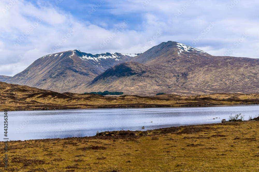 A view across the Loch of the Armpit towards an ice age corrie near Glencoe, Scotland on a summers day