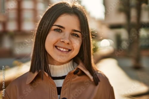 Young beautiful brunette woman smiling happy outdoors
