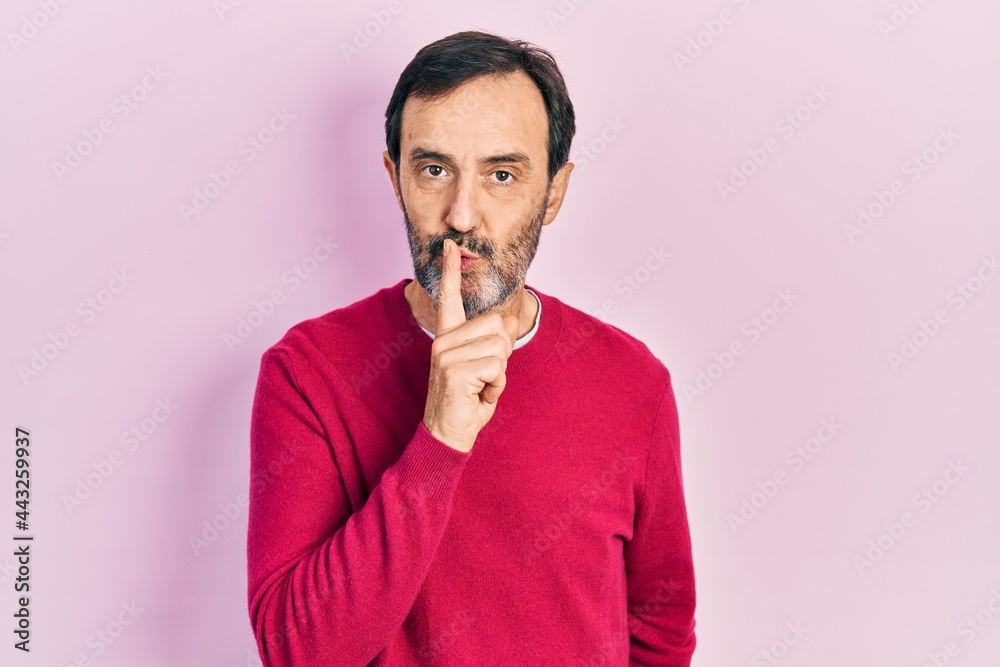 Middle age hispanic man wearing casual clothes asking to be quiet with finger on lips. silence and secret concept. Middle age hispanic man wearing casual clothes asking to be quiet with finger on lips. silence and secret concept.