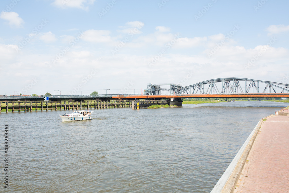 View of daytrippers on electric bikes resting alongside the IJssel river in Zutphen, The Netherlands. View of daytrippers on electric bikes resting alongside the IJssel river in Zutphen, The Netherlands.