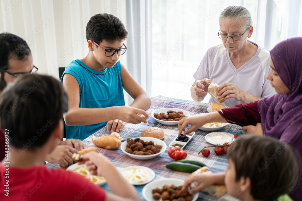 Happy family enjoying eating food in dining room