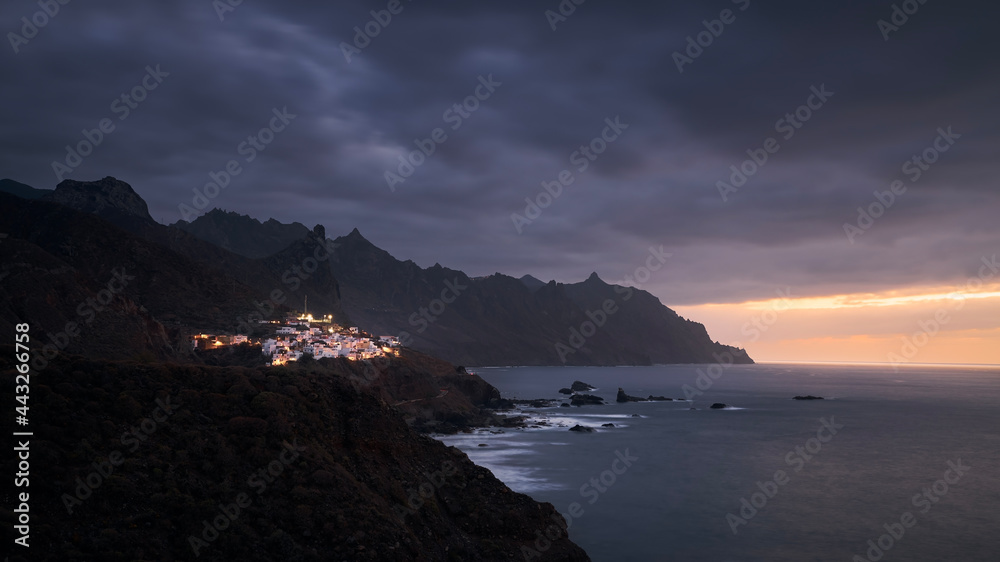 Cliffs in north coastline of Tenerife at moody sunset. Village in Anaga mountains, Tenerife, Canary Islands, Spain.