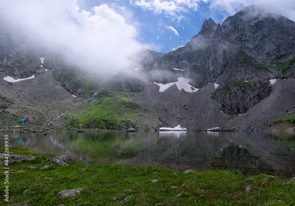 Avusor Plateau and Kaçkar Mountains with blue cloudy sky background. Crater lake at the top of the plateau Avusor Plateau and Kaçkar Mountains with blue cloudy sky background. Crater lake at the top of the plateau