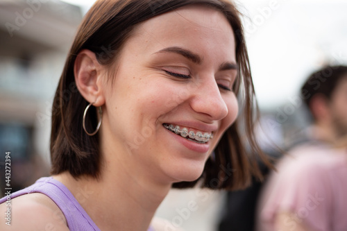 Young girl smiling with metal dental braces on teeth