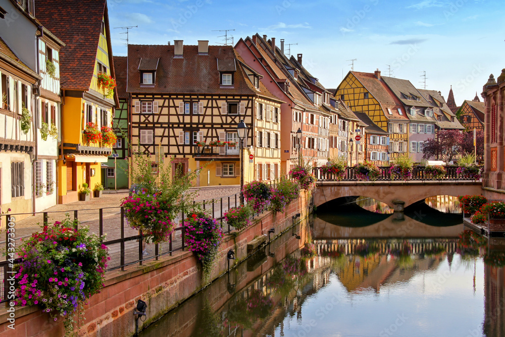 Colmar, France, late day view with half timbered houses, flowers, bridge and reflections in the beautiful canals