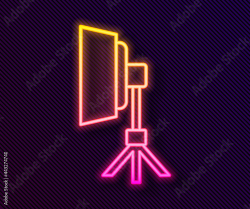 Glowing neon line Studio light bulb in softbox icon isolated on black background. Shadow reflection design. Vector