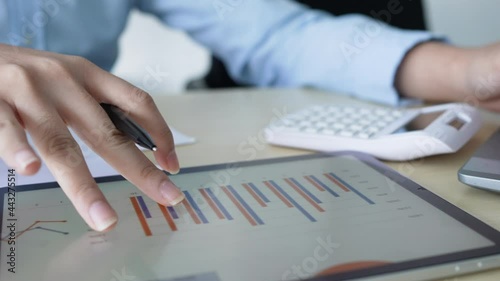 slow motion scene salesman employee hand using stylus pen to pointing on tablet screen to show company profit monthly in the meeting event at conference room , business strategy concept	