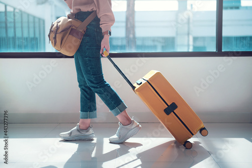 Fényképezés Closeup - Travel tourist with luggage or suitcase in airport terminal