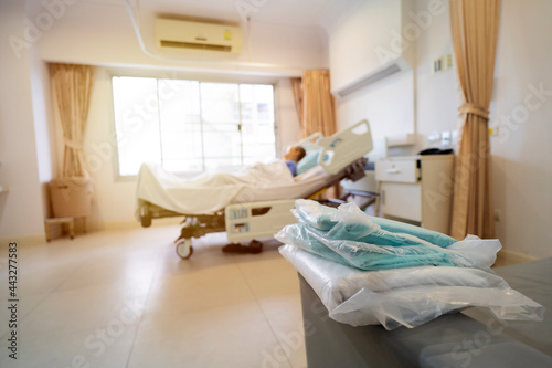 Patient on hospital bed, medical blur interior background white room.