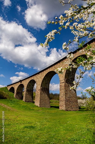 Old railway stone viaduct in the spring in sunny day. photo