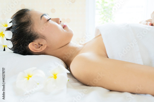 woman lying down on massage beds at Asian luxury spa and wellness center