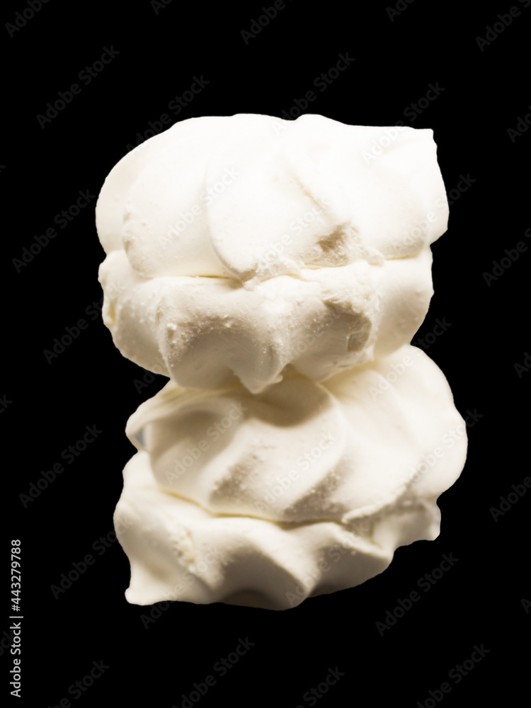 Two white marshmallows on a black background Two white marshmallows on a black background