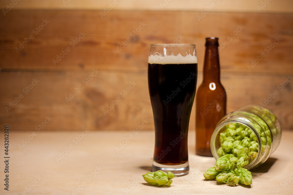 Glass of dark beer with hops