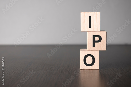 Businesswoman made word ipo with wood building blocks.