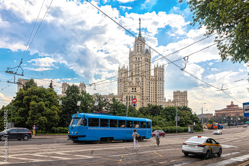 Blue tram at a tram stop against the background of a skyscraper on the Kotelnicheskaya photo