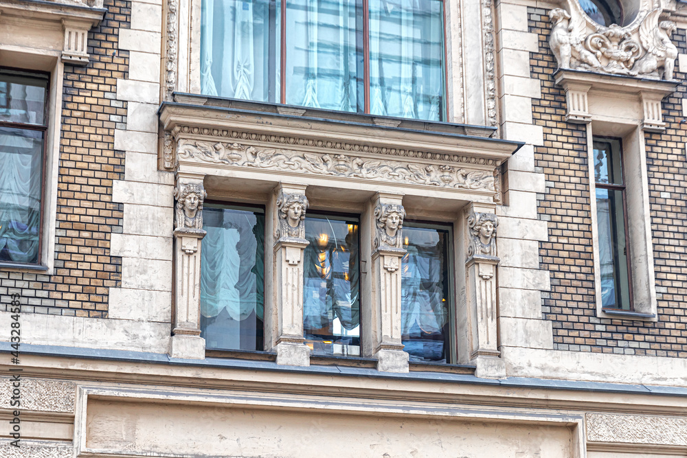 Window of a merchant's apartment house with pilasters and a decorative frieze