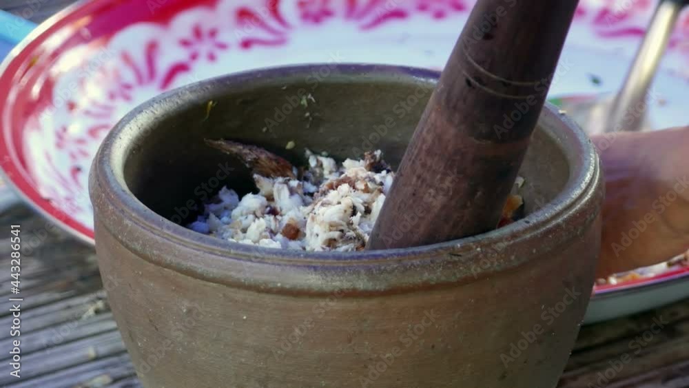 chef cooking Thai cuisine nam prik or chili paste mixes with fish chef cooking Thai cuisine nam prik or chili paste mixes with fish
