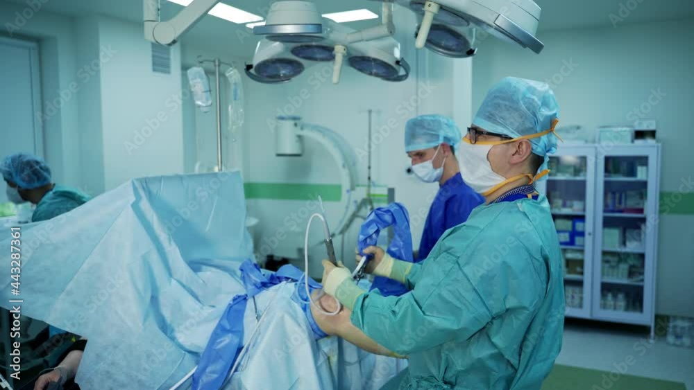 Process of trauma surgery operation. Group of surgeons in operating room with surgery equipment. Process of trauma surgery operation. Group of surgeons in operating room with surgery equipment.