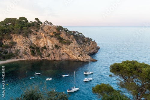 Remote and wild Mediterranean beach with boats