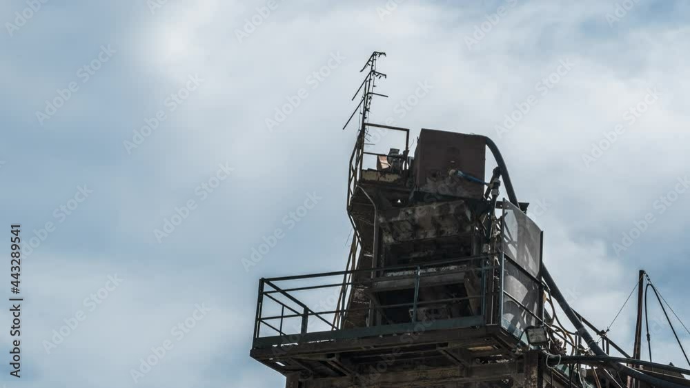 Clouds drift behind a tower of an abandoned factory, timelapse shot Clouds drift behind a tower of an abandoned factory, timelapse shot