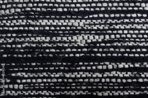 Fabric texture weave a large wool thread. Black and white material. Woven textured background with copy space. Top view