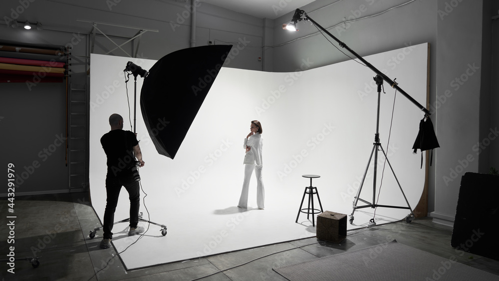 Fashion photography in a photo studio. Professional male photographer