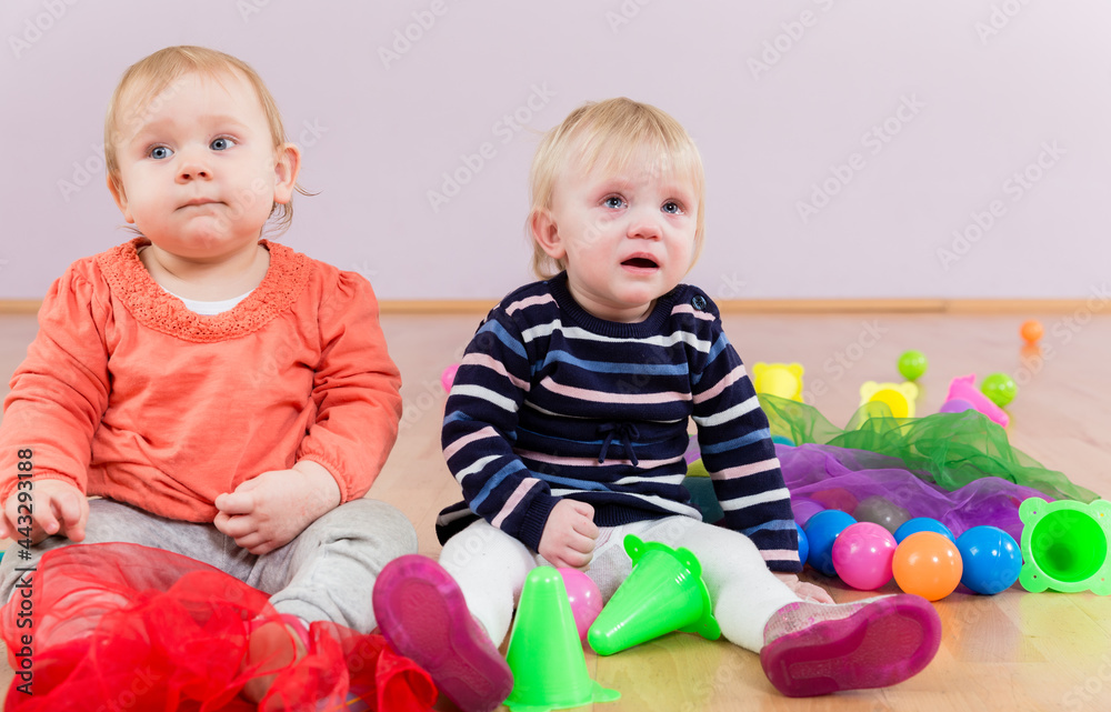 Baby crying next to another toddler in kindergarten Baby crying next to another toddler in kindergarten