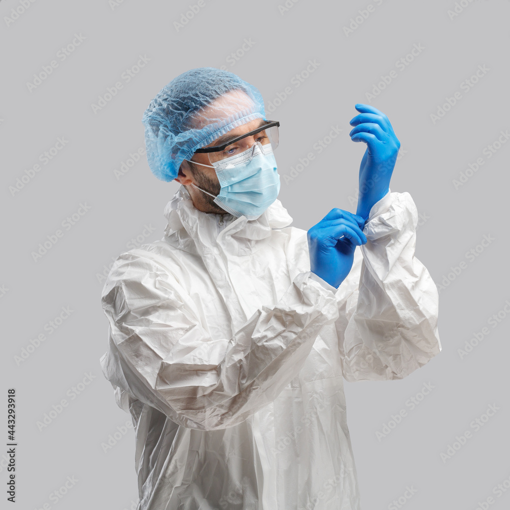 A man in a protective antibacterial suit. The concept of anti-epidemic measures. A warning sign. AntiCOVID. Vaccine against coronavirus A man in a protective antibacterial suit. The concept of anti-epidemic measures. A warning sign. AntiCOVID. Vaccine against coronavirus