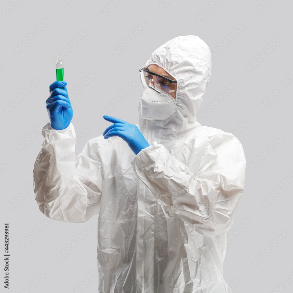 A man in a protective antibacterial suit. The concept of anti-epidemic measures. A warning sign. AntiCOVID. Vaccine against coronavirus A man in a protective antibacterial suit. The concept of anti-epidemic measures. A warning sign. AntiCOVID. Vaccine against coronavirus