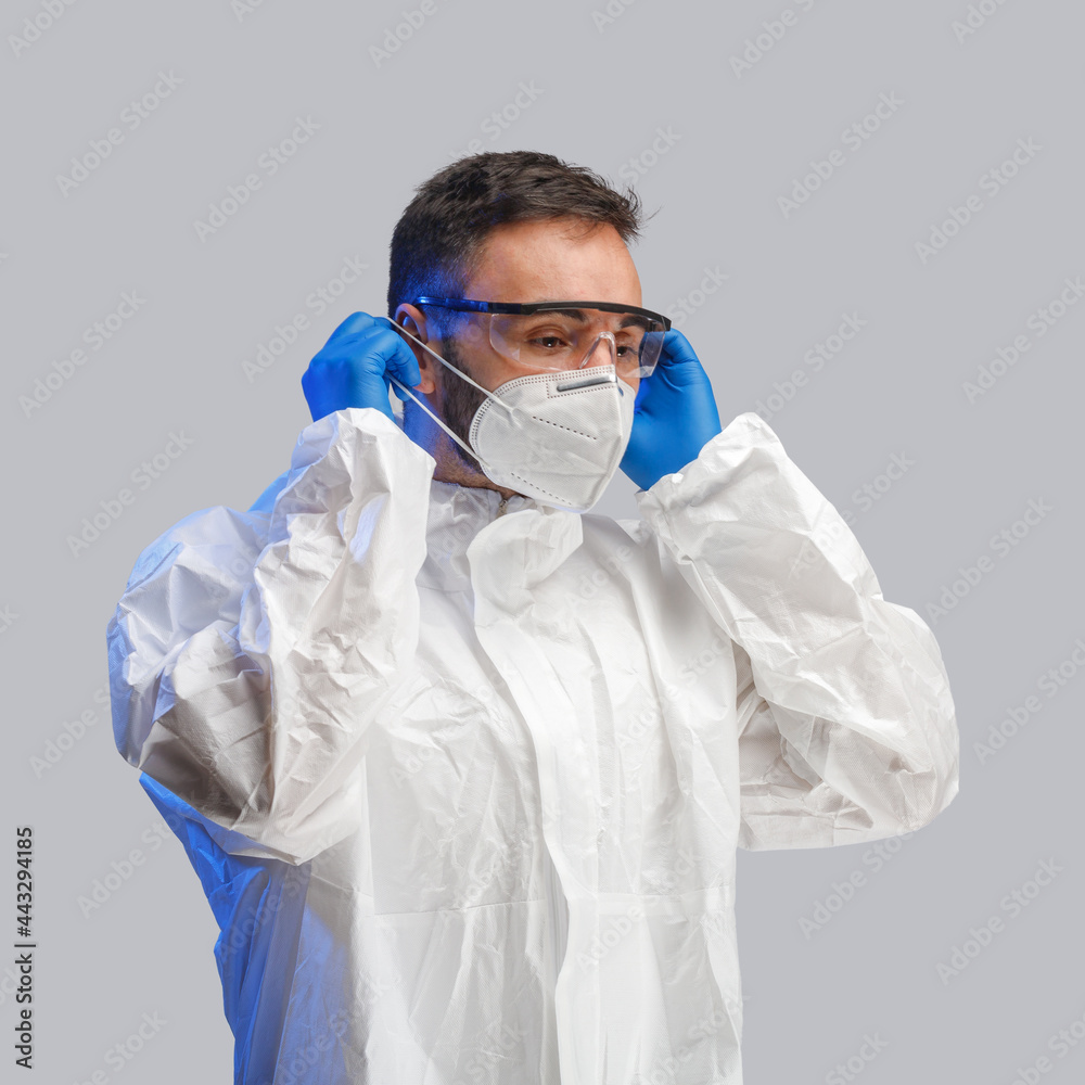 A man in a protective antibacterial suit. The concept of anti-epidemic measures. A warning sign. AntiCOVID. Vaccine against coronavirus A man in a protective antibacterial suit. The concept of anti-epidemic measures. A warning sign. AntiCOVID. Vaccine against coronavirus