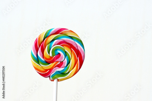 Colorful lollipop on a white background. Round multi-colored candy. 