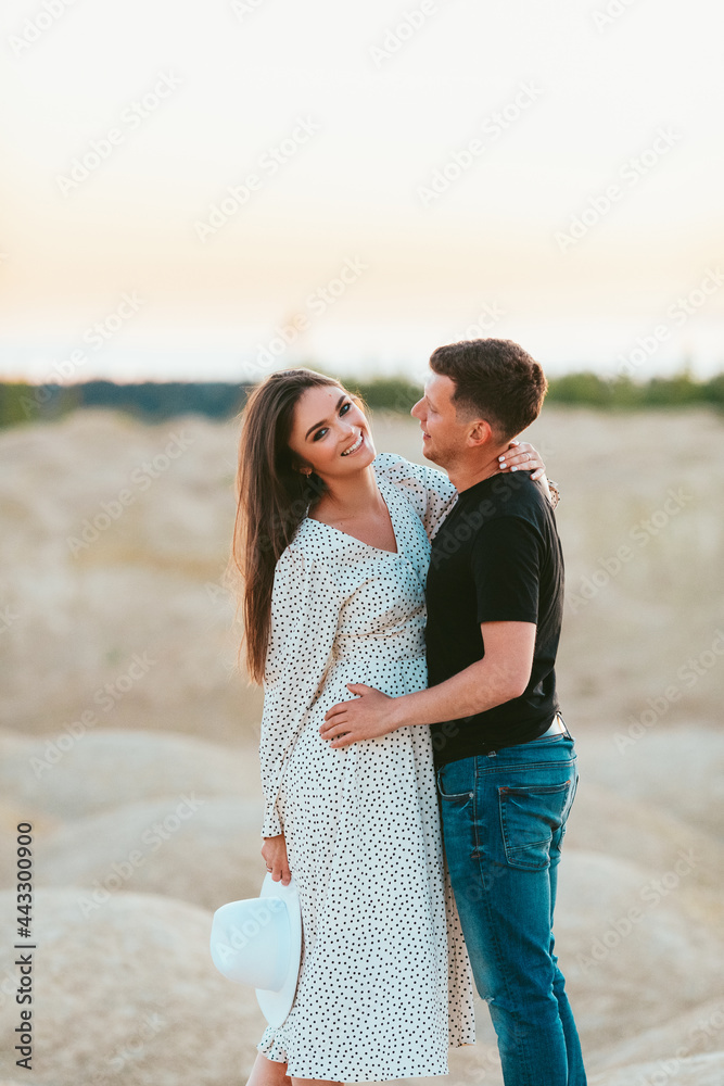 beautiful couple on the sand dunes at dawn beautiful couple on the sand dunes at dawn