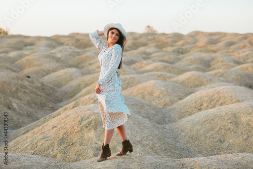 Young beautiful girl on the sand dunes at dawn