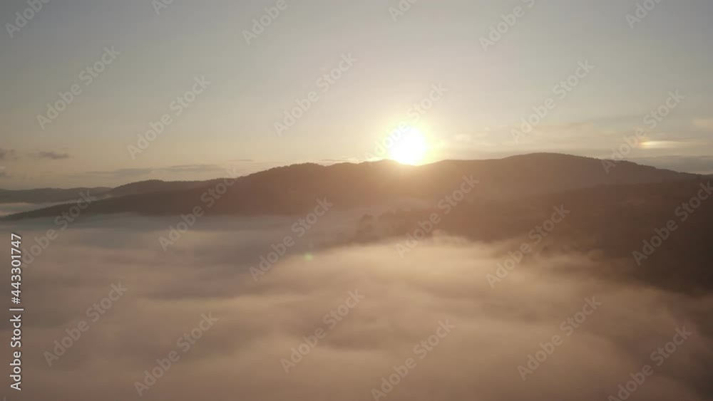 Aerial top drone view above the clouds and sky in wonderful morning sunrise time. Inspiration concept. Flying through the clouds above mountain tops. Beautiful sunset mountain ridge Aerial top drone view above the clouds and sky in wonderful morning sunrise time. Inspiration concept. Flying through the clouds above mountain tops. Beautiful sunset mountain ridge