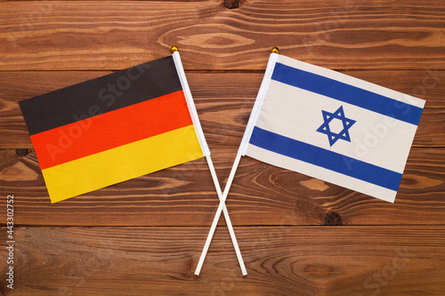 Flag of Germany and flag of Israel crossed with each other. The image illustrates the relationship between countries. Photography for video news on TV and articles on the Internet and media.