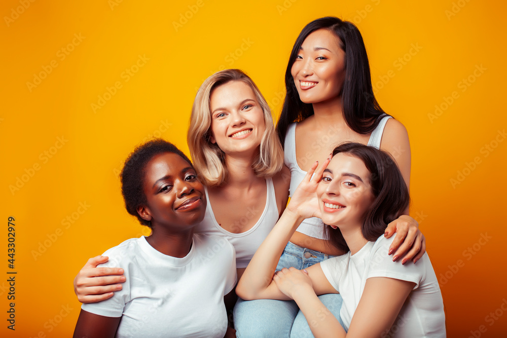 diverse multi nation girls group, teenage friends company cheerful having fun, happy smiling, cute posing on yellow background, lifestyle people concept, african-american, asian and caucasian diverse multi nation girls group, teenage friends company cheerful having fun, happy smiling, cute posing on yellow background, lifestyle people concept, african-american, asian and caucasian