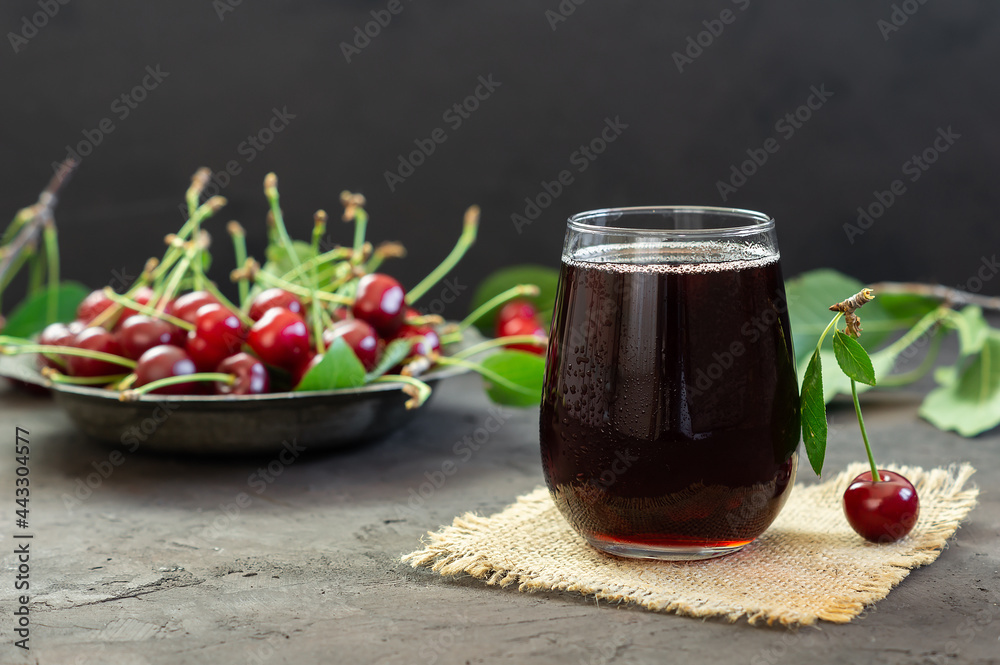 Glass of sour cherry juice with fresh red cherries, summer juice Glass of sour cherry juice with fresh red cherries, summer juice