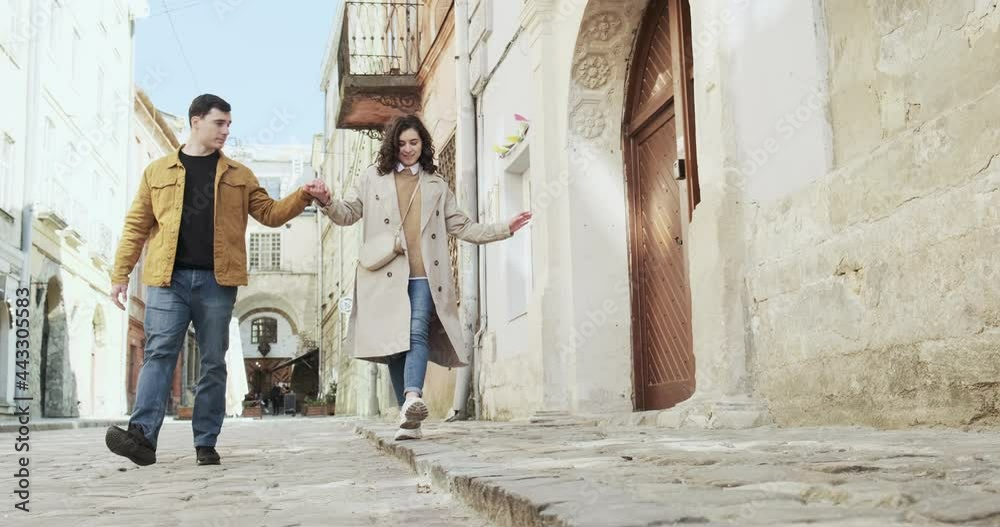 Sweet couple have vacation in old european town. Happy young lovers enjoy time spending together. Walking together in travel Sweet couple have vacation in old european town. Happy young lovers enjoy time spending together. Walking together in travel