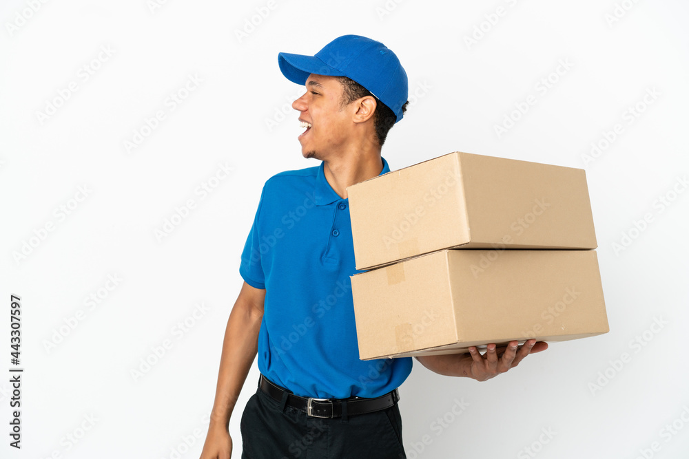 Delivery African American man isolated on white background laughing in lateral position Delivery African American man isolated on white background laughing in lateral position