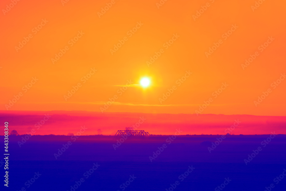 Blue land and orange sky with sunset . Imaginary twilight